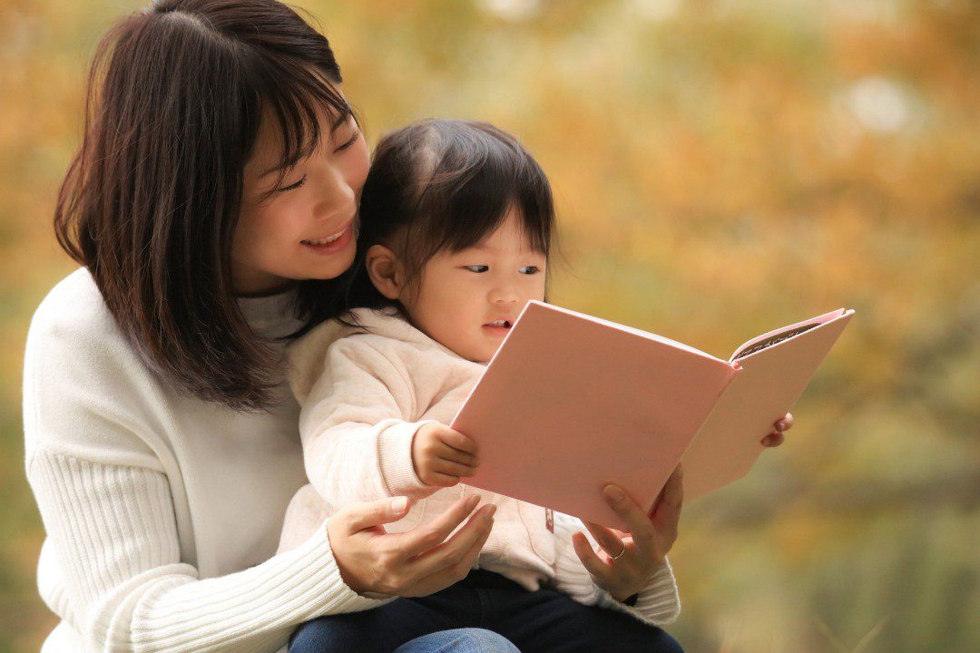 Mother reads to her daughter.