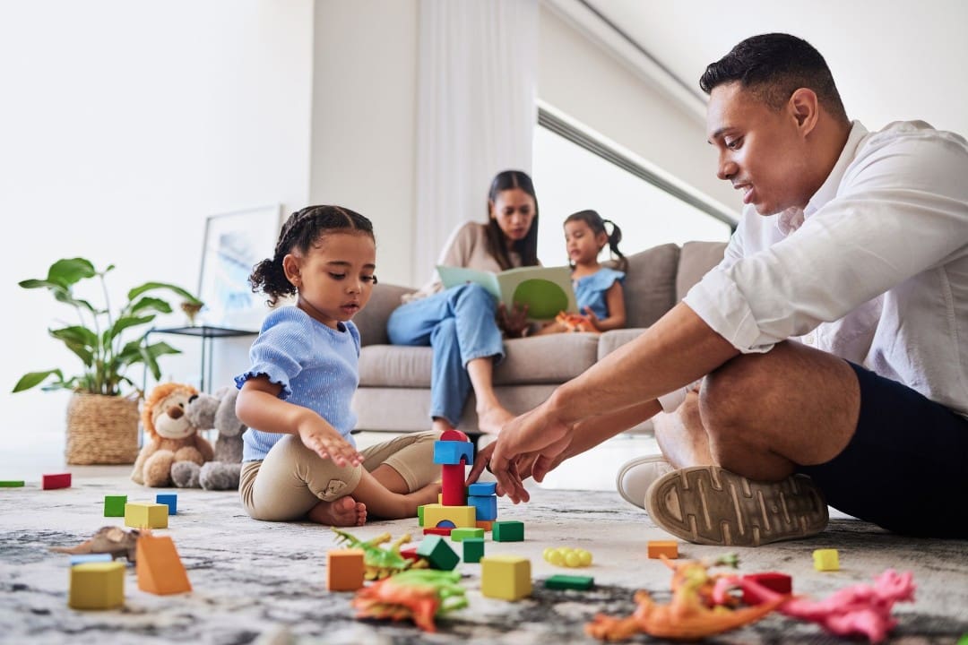 Young girl concentrates on building with blocks.