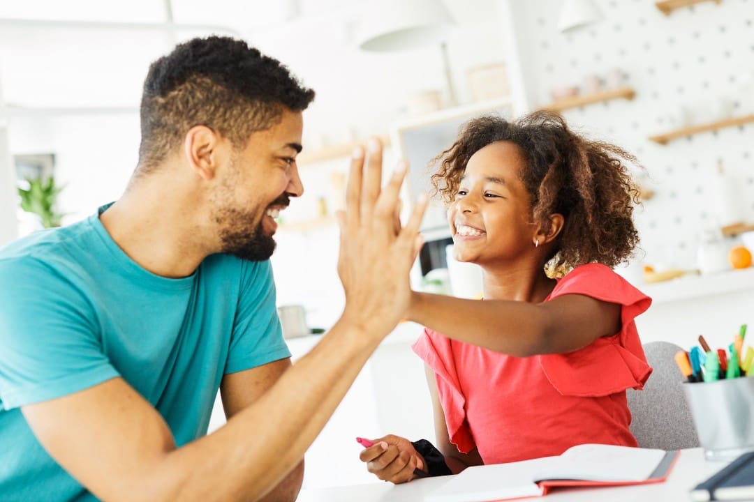 Parent praising child to build confidence before kindergarten