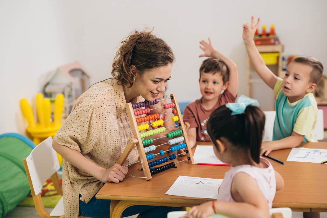 Child care teacher with students in a classroom