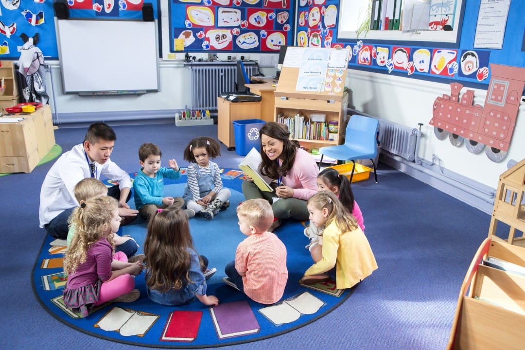 Preschool kids in circle time with teachers