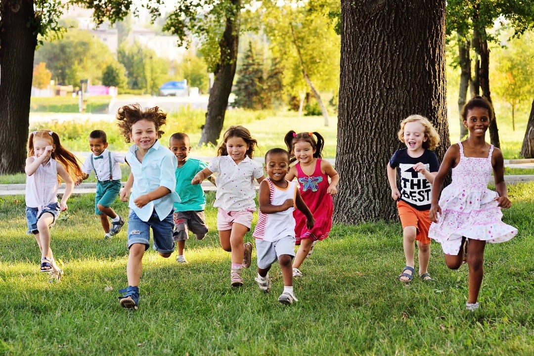 Preschool kids running outdoors