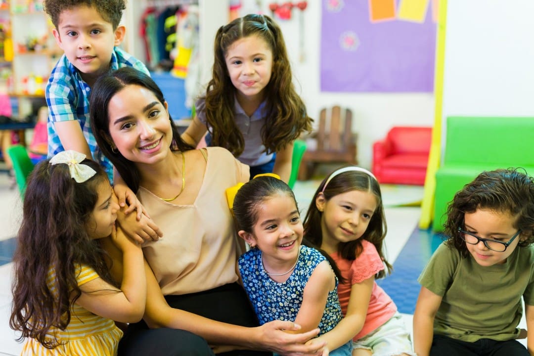 preK teacher with a group of students in a child care classroom