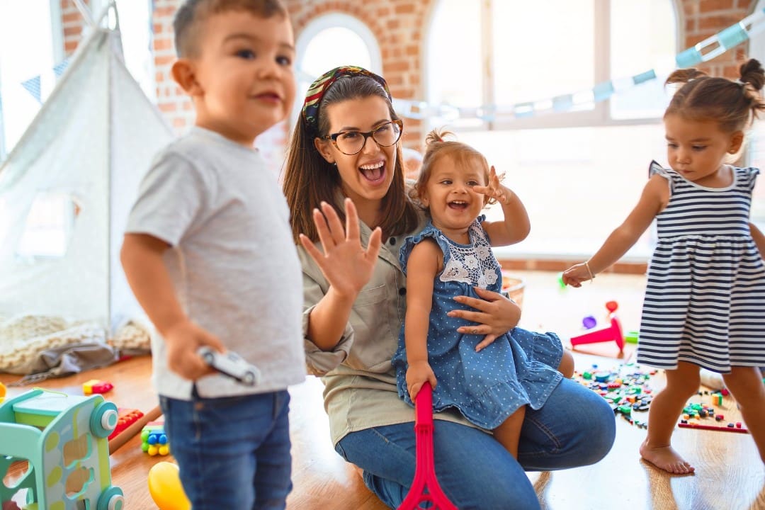 Teacher surrounded by a group of kids in a licensed child care center