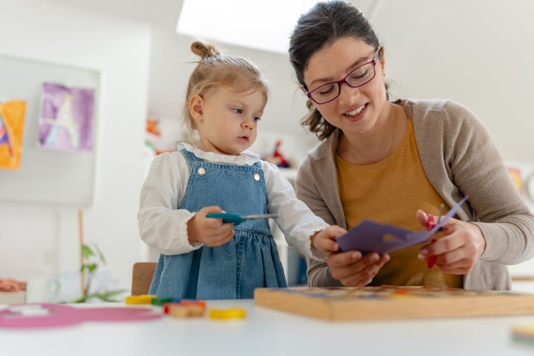 Licensed child care teacher with young girl